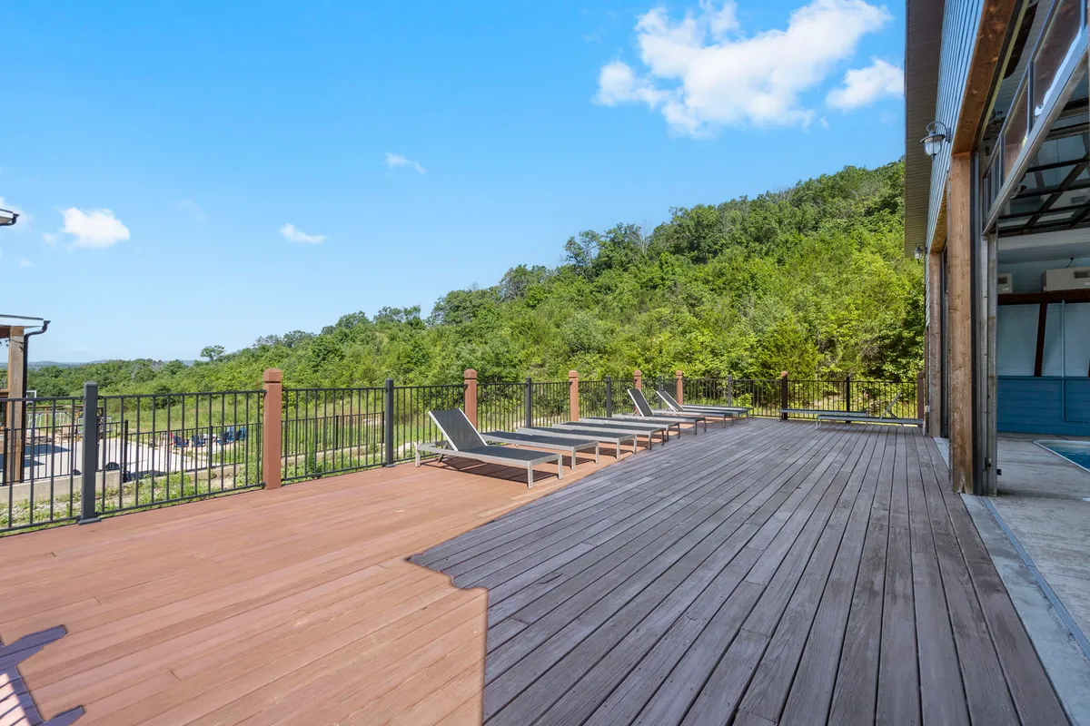 A spacious outdoor deck with lounge chairs set among lush greenery. The area is perfect for unwinding, enjoying the fresh air, and spending time with your furry companion after a walk on the trails.