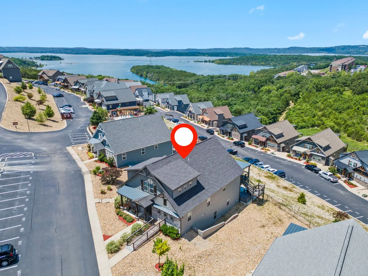 A serene view of the lake surrounded by houses and lush landscaping, ideal for boating, fishing, or simply enjoying the natural beauty of the area.