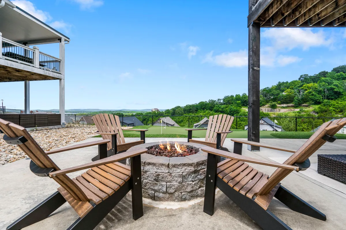 The hero image showcases a cozy outdoor fire pit surrounded by Adirondack chairs, set against a stunning landscape with sunset views. The scene captures guests gathered around the fire, enjoying warm firelight and the inviting ambiance, with ample space for relaxation and shared outdoor meals. The tranquil setting overlooks natural beauty, evoking a sense of togetherness and retreat.